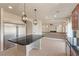 An open concept kitchen featuring stainless steel appliances, a center island, and seamless flow to the living area at 9853 Russian Hill St, Las Vegas, NV 89141