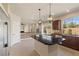A bright kitchen with granite countertops, stainless appliances, an island, and a seamless transition to the outdoor space at 9853 Russian Hill St, Las Vegas, NV 89141
