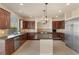 A modern kitchen featuring stainless steel appliances, tile flooring, and granite countertops, perfect for culinary enthusiasts at 9853 Russian Hill St, Las Vegas, NV 89141