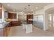 A spacious kitchen with stainless steel appliances, dark wood cabinets, tile flooring, and ample countertop space at 9853 Russian Hill St, Las Vegas, NV 89141