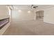 Expansive living room with modern fireplace, neutral carpet, and decorative pillars at 9853 Russian Hill St, Las Vegas, NV 89141