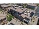 Stunning aerial view of a multi-story townhome with a tile roof, multiple balconies, and solar panels at 10013 Sable Point St, Las Vegas, NV 89178