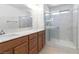 Modern bathroom with walk-in shower, marble countertops and wood cabinets at 10013 Sable Point St, Las Vegas, NV 89178