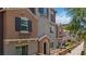 Attractive townhome exterior showcasing decorative window boxes, elegant shutters, and a quaint covered entrance at 10013 Sable Point St, Las Vegas, NV 89178
