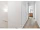 Upstairs hallway with neutral carpet and view into a bright bathroom at 10013 Sable Point St, Las Vegas, NV 89178