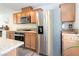 Kitchen with stainless steel refrigerator, granite countertops, and wood cabinets at 10013 Sable Point St, Las Vegas, NV 89178