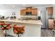 Open kitchen with granite countertops, stainless steel appliances, and bar seating at 10013 Sable Point St, Las Vegas, NV 89178