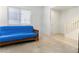 Neutral room featuring a blue futon with a staircase leading to upper level at 10013 Sable Point St, Las Vegas, NV 89178