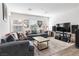 Cozy living room with plush sofas, natural light, and a contemporary entertainment center at 10013 Sable Point St, Las Vegas, NV 89178