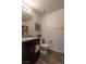 Well-lit bathroom featuring dark cabinets, granite countertop and modern fixtures at 12237 Plum Mist Ct # 4, Las Vegas, NV 89183