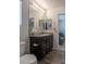 Modern bathroom design with dual mirrors, granite counters, and stylish fixtures at 12237 Plum Mist Ct # 4, Las Vegas, NV 89183