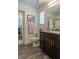 Well-lit bathroom with dark wood cabinets and granite countertops at 12237 Plum Mist Ct # 4, Las Vegas, NV 89183