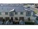 Modern townhome featuring a gray tile roof, attached garage, and manicured landscaping at 12237 Plum Mist Ct # 4, Las Vegas, NV 89183