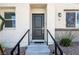Inviting front entrance featuring a stylish black door, concrete steps, and sleek black railings at 12237 Plum Mist Ct # 4, Las Vegas, NV 89183