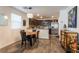 Open-concept kitchen featuring dark wood cabinetry, stainless steel appliances, and granite countertops at 12237 Plum Mist Ct # 4, Las Vegas, NV 89183