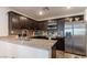 Modern kitchen showcases dark wood cabinets, granite countertops, stainless appliances, and stylish backsplash at 12237 Plum Mist Ct # 4, Las Vegas, NV 89183
