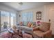 Inviting living room featuring a cozy sofa, a plush armchair, and a decorative rug, creating a warm and welcoming atmosphere at 12237 Plum Mist Ct # 4, Las Vegas, NV 89183