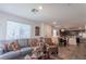 Open-concept living room and dining area with a view of the kitchen boasts natural light at 12237 Plum Mist Ct # 4, Las Vegas, NV 89183