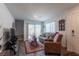 Cozy living room with ample natural light, a comfortable sofa, and a sliding door to the back patio at 12237 Plum Mist Ct # 4, Las Vegas, NV 89183