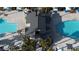 Aerial view of a community pool with palm trees and lounge chairs at 12237 Plum Mist Ct # 4, Las Vegas, NV 89183