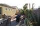 Backyard with desert landscaping, outdoor kitchen, patio, and mature foliage at 1504 Andrew David Ave, North Las Vegas, NV 89086