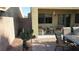 Backyard with a covered patio and outdoor seating, cactus, and desert landscaping at 1504 Andrew David Ave, North Las Vegas, NV 89086