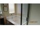 Bright bathroom featuring a soaking tub with jets, a shower with glass doors, and neutral tones at 1504 Andrew David Ave, North Las Vegas, NV 89086