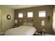 Cozy bedroom with decorative mirrors and lamps, soft lighting, and a comfortable bed at 1504 Andrew David Ave, North Las Vegas, NV 89086