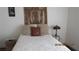 Cozy bedroom featuring unique headboard art, accent pillows and matching lamps at 1504 Andrew David Ave, North Las Vegas, NV 89086