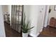 Inviting hallway with decorative mirror, house plant, and wooden floors for a warm, stylish entryway at 1504 Andrew David Ave, North Las Vegas, NV 89086