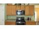 Well-equipped kitchen featuring granite counters, stainless steel oven and microwave at 1504 Andrew David Ave, North Las Vegas, NV 89086