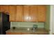 Kitchen featuring wooden cabinetry and granite countertop at 1504 Andrew David Ave, North Las Vegas, NV 89086