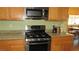 Modern kitchen with stainless steel appliances and wooden cabinets at 1504 Andrew David Ave, North Las Vegas, NV 89086