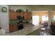 Modern kitchen featuring granite countertops, wooden cabinets, and stainless steel appliances at 1504 Andrew David Ave, North Las Vegas, NV 89086
