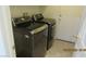 Laundry room featuring modern, front-load washer and dryer units for convenience at 1504 Andrew David Ave, North Las Vegas, NV 89086