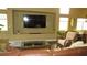 Spacious living room featuring a large TV, built-in shelves, and cozy furniture at 1504 Andrew David Ave, North Las Vegas, NV 89086