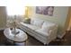 Comfortable living room with stylish white sofa, decorative pillows, and a uniquely designed coffee table at 1504 Andrew David Ave, North Las Vegas, NV 89086