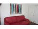 A vibrant living room with a red sofa and artwork at 1504 Andrew David Ave, North Las Vegas, NV 89086