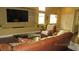 Comfortable living room featuring a large TV, built-in shelf, and a cozy seating arrangement at 1504 Andrew David Ave, North Las Vegas, NV 89086