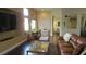 Bright living room with hardwood floors, a large TV, and open access to other rooms at 1504 Andrew David Ave, North Las Vegas, NV 89086