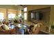 Open-concept living room with hardwood floors, lots of plants, and a view into the dining area at 1504 Andrew David Ave, North Las Vegas, NV 89086