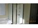 Clean, glass-enclosed shower with white tiled walls and bright natural light at 1504 Andrew David Ave, North Las Vegas, NV 89086