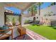 Inviting backyard with a custom play structure, hammocks, covered patio, and artificial turf at 189 Andada Dr, Henderson, NV 89012