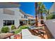 Inviting backyard features artificial turf, mature palm trees, lounge chairs and unique decor at 189 Andada Dr, Henderson, NV 89012