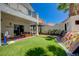 Great backyard featuring a custom climbing wall, patio area, and manicured artificial turf at 189 Andada Dr, Henderson, NV 89012