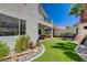 Landscaped backyard with rock border, play area, charming patio, and artificial turf at 189 Andada Dr, Henderson, NV 89012