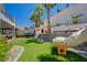 Lush backyard showcasing a play structure with slide, climbing wall, and well-manicured artificial grass at 189 Andada Dr, Henderson, NV 89012