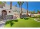 Spacious backyard featuring a playhouse, climbing wall, slide, and artificial turf at 189 Andada Dr, Henderson, NV 89012