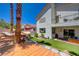 Beautiful backyard with patio, lush artificial turf, playhouse, and mature palm trees at 189 Andada Dr, Henderson, NV 89012