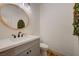 Stylish half bathroom features modern fixtures, round mirror, and chic decor at 189 Andada Dr, Henderson, NV 89012
